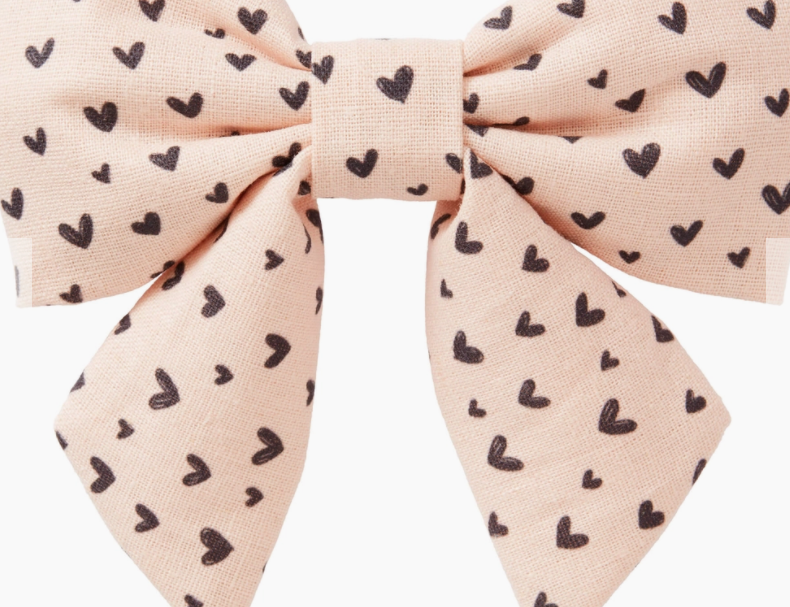 Foggy Dog Lady Dog Bow, a blush pink bow with a small black heart print