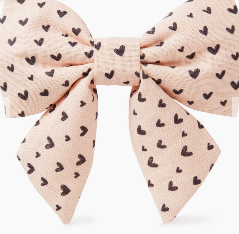 Foggy Dog Lady Dog Bow, a blush pink bow with a small black heart print