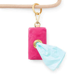 Foggy Dog Poop Bag Holder in Hot Pink clipped to a leash with a bag pulled through the grommet