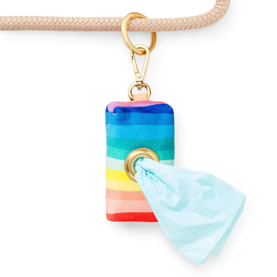Foggy Dog Poop Bag Holder in Over the Rainbow clipped to a leash with a bag pulled through