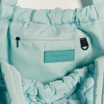 Free People Movement Cloud 9 tote in pistachio, close up of the gathered drawstring top and label