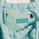 Free People Movement Cloud 9 tote in pistachio, close up of the gathered drawstring top and label