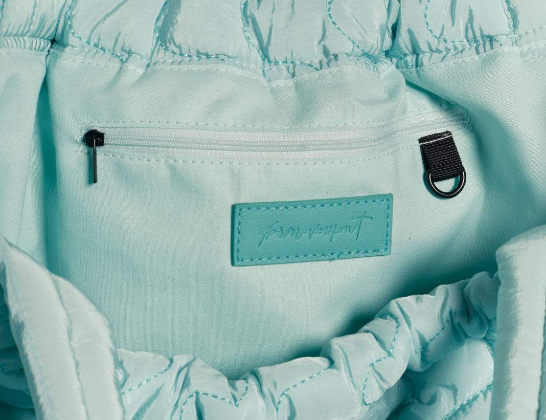 Free People Movement Cloud 9 tote in pistachio, close up of the gathered drawstring top and label