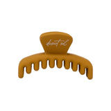 Frenchie claw clip in Honey, petite size, a matte mustard yellow hair claw clip with desert sol script on the top tab, on a white background.