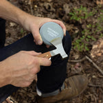 Hands sharpening a pocket knife on the Gentlemen's Hardware Sharpening Stone outdoors