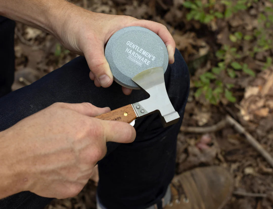 Hands sharpening a pocket knife on the Gentlemen's Hardware Sharpening Stone outdoors