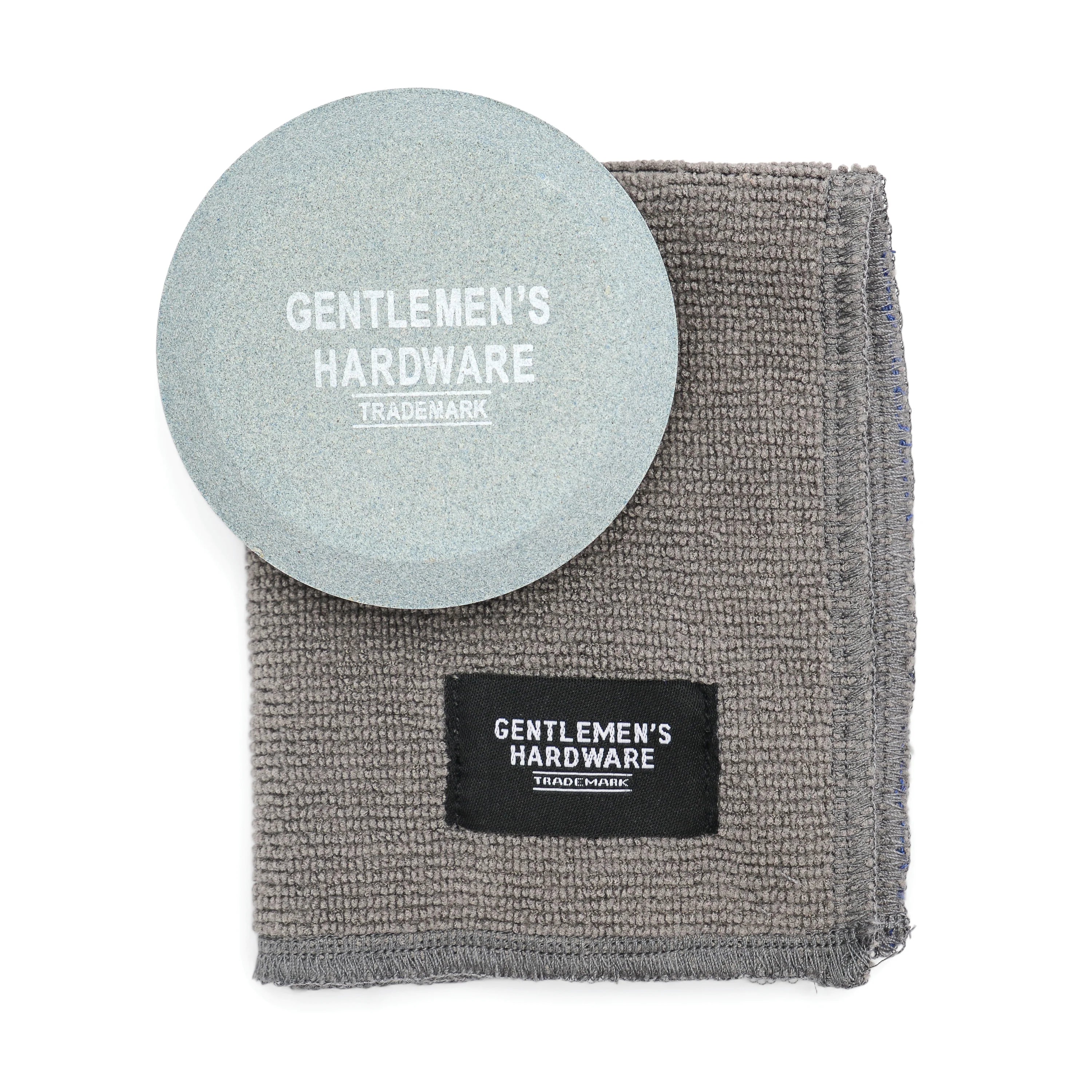 Gentlemen's Hardware Sharpening Stone, a round gray stone with a gray cleaning cloth