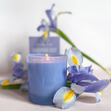 GP Candle Co Midnight 9oz Candle lit and surrounded by purple irises