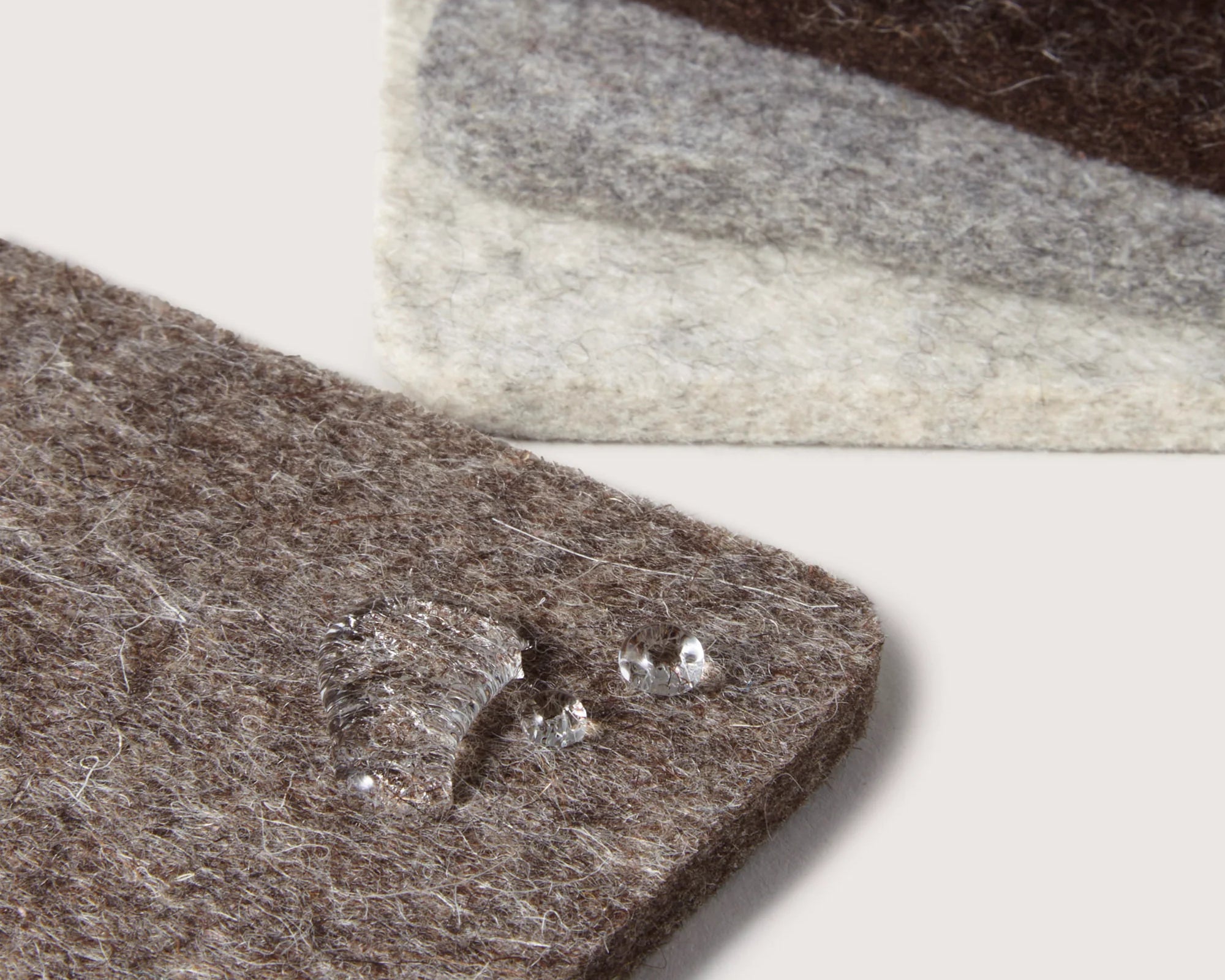 Close-up of water droplets beading on the Graf Lantz Bierfilzl Square Coasters in Earth
