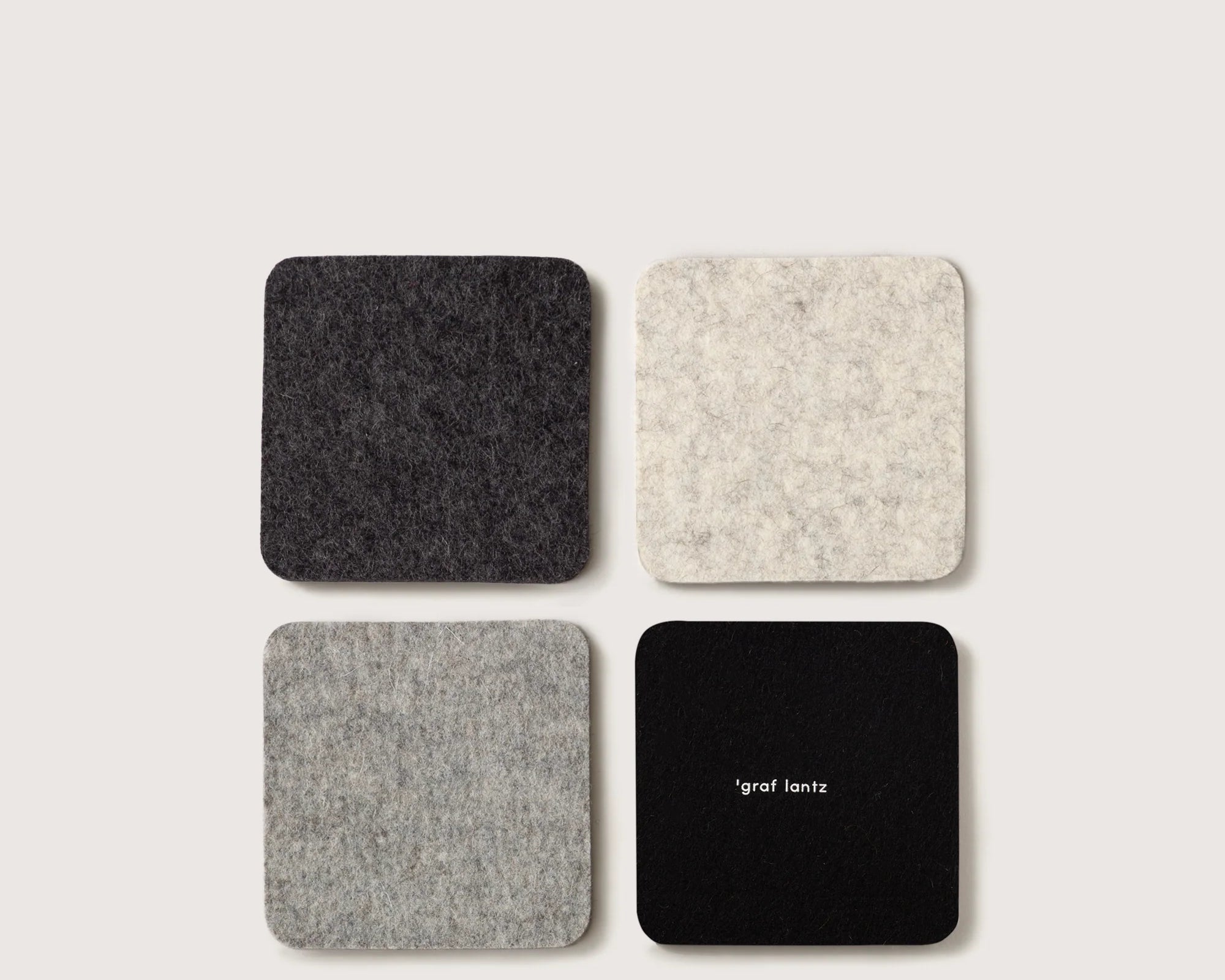 Graf Lantz Bierfilzl Merino Wool Square Coasters in Noir, four felt coasters in charcoal, cream, gray and black