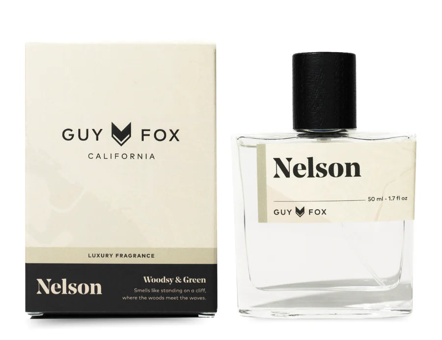 Guy Fox Nelson Men's Cologne, a clear glass bottle with a black cap beside its cream and black box
