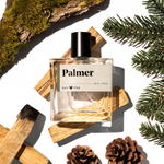 Guy Fox Palmer Men's Cologne bottle with cedar wood blocks, pine sprigs and pinecones