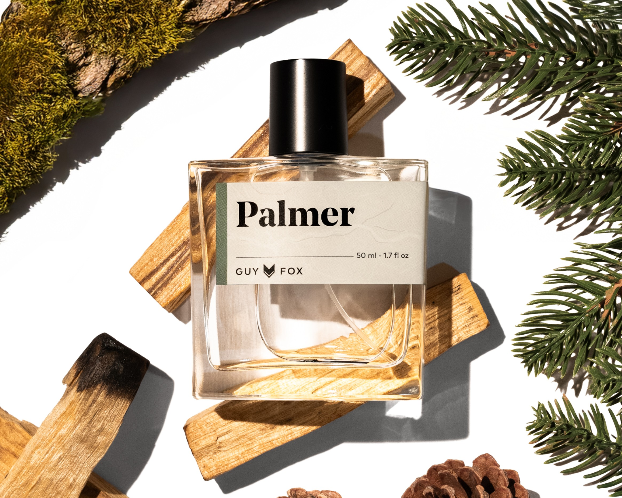 Guy Fox Palmer Men's Cologne bottle with cedar wood blocks, pine sprigs and pinecones
