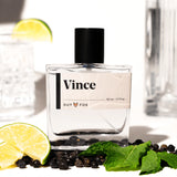 Guy Fox Vince Cologne bottle with lime wedges, mint and black peppercorns
