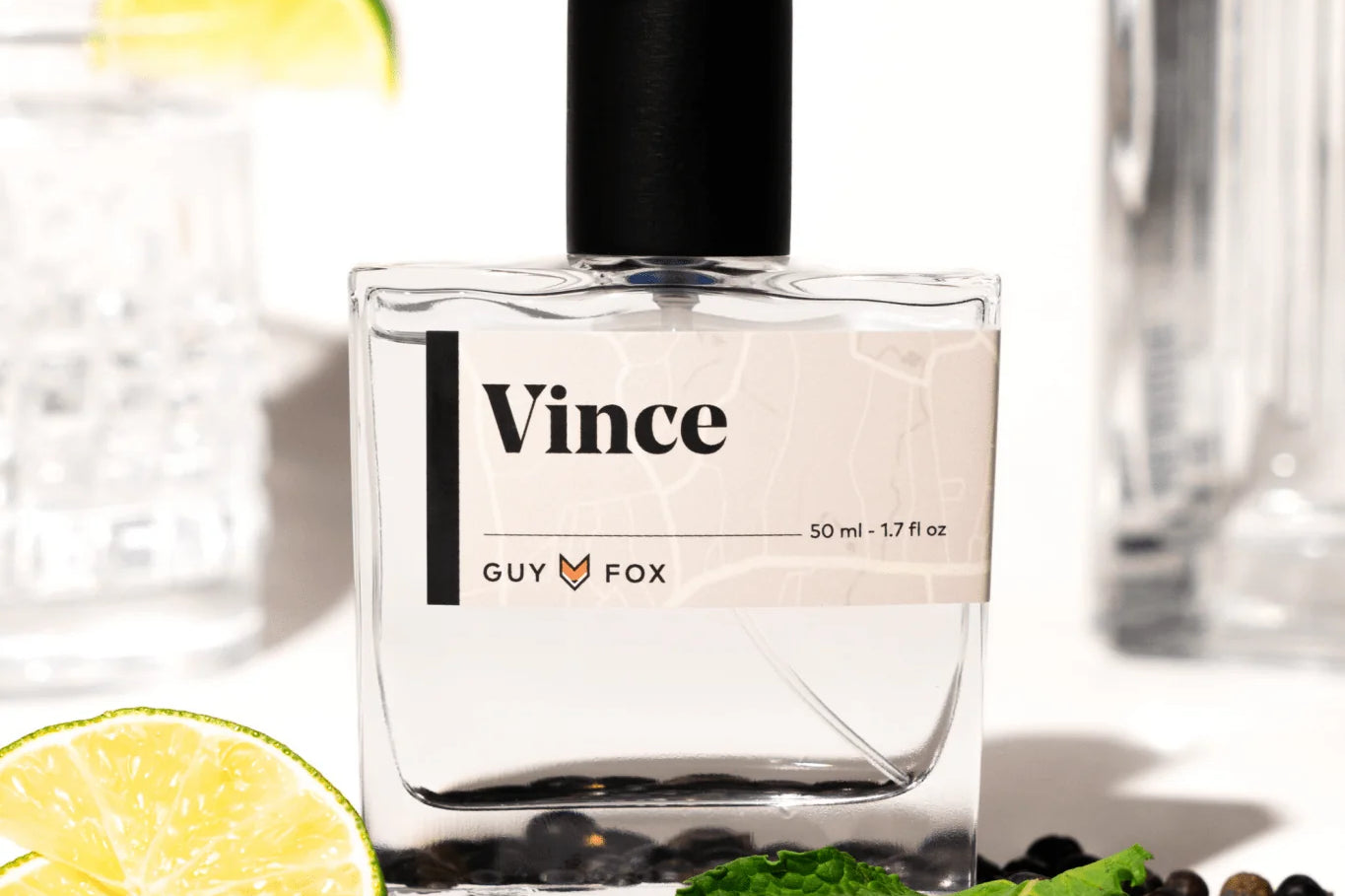 Guy Fox Vince Cologne bottle with lime wedges, mint and black peppercorns
