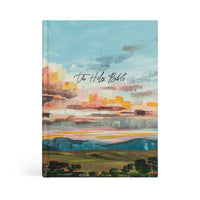 Hosanna Revival ESV Journaling Bible in the Santa Lucia theme, a painted sunset landscape cover over green hills