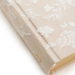 Close-up of the embossed floral cover and gold edges on the Hosanna Revival NLT Compact Bible Casablanca theme