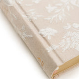 Close-up of the embossed floral cover and gold edges on the Hosanna Revival NLT Compact Bible Casablanca theme