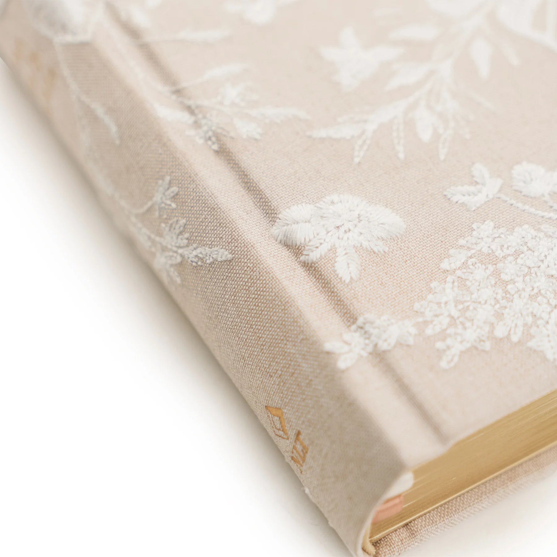 Close-up of the embossed floral cover and gold edges on the Hosanna Revival NLT Compact Bible Casablanca theme
