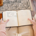 Hands holding the Hosanna Revival One Thing I Ask prayer journal open to a July 19 page