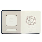 Hosanna Revival One Thing I Ask prayer journal open to the title page with a gold wreath