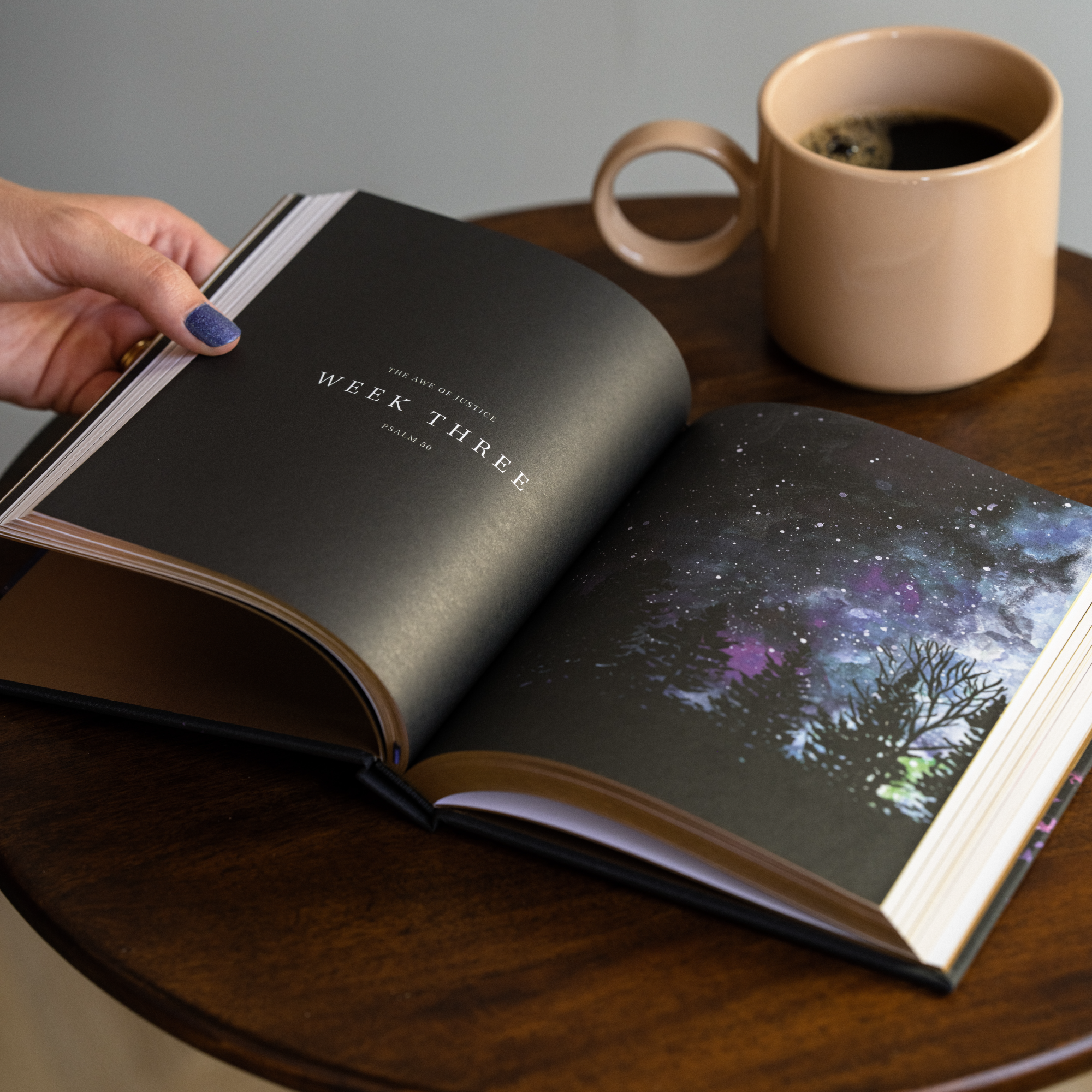 Hosanna Revival Wonder by Alicia Hamilton open to the Week Three page on a table with a mug of coffee