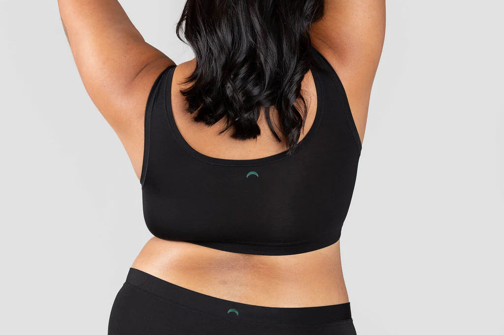 Back view of a woman wearing the Huha Mineral Cheeky underwear and bralette in Black