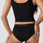 Back view of the Huha Mineral Cheeky underwear in Black worn with a black tank