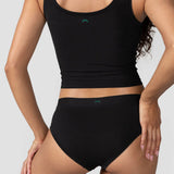 Back view of the Huha Mineral Cheeky underwear in Black worn with a black tank