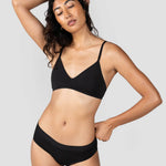 Woman with hand behind her head wearing the Huha Mineral Cheeky underwear and bralette in Black