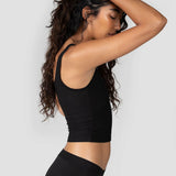 Side view of a woman wearing the Huha Mineral Cheeky underwear and tank in Black