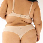 Close-up back view of the Huha Seamless Low Mid Thong and bralette in Beige