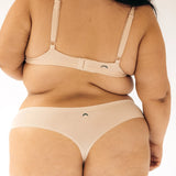 Close-up back view of the Huha Seamless Low Mid Thong and bralette in Beige