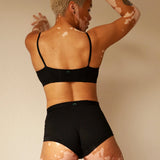 Back view of a woman wearing the Huha Tata Bralette and boxer briefs in Black