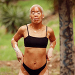 Woman outdoors wearing the Huha Tata Bralette and underwear in Black