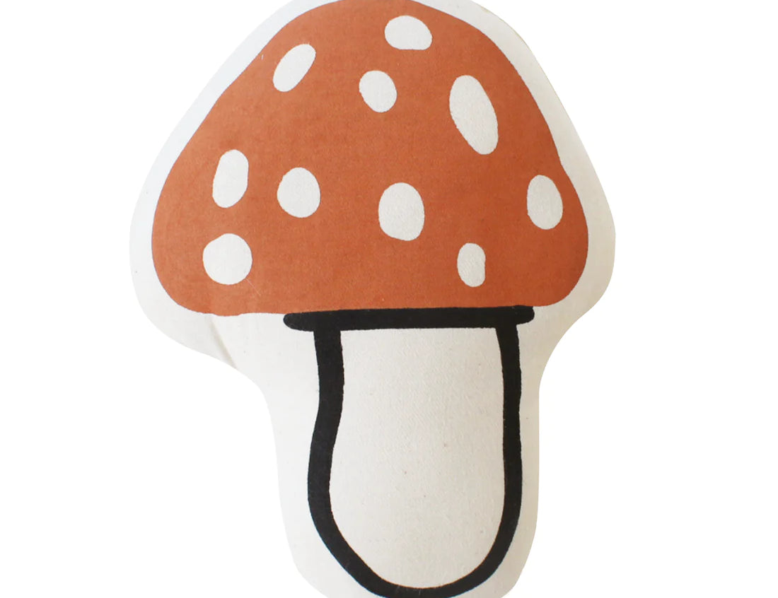 Imani Collective Mushroom Pillow, a rust red spotted toadstool-shaped canvas pillow