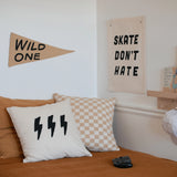 Imani Collective Wild One Pennant on a bedroom wall beside a Skate Don't Hate banner