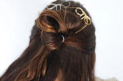 Kaxi Bow Pins in Silver and gold tucked into a half-up brunette hairstyle