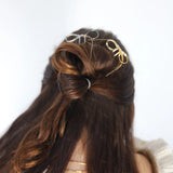 Kaxi Bow Pins in Silver and gold tucked into a half-up brunette hairstyle