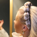 Close-up of the braided checkered Kaxi GRWM Headband in Beige worn in blonde hair