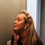 Woman in profile wearing the Kaxi GRWM Headband in Neutral Checkered