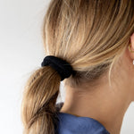Kaxi The Hold All Day Hair Tie in Black holding a low blonde ponytail, back view