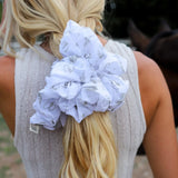Kaxi Jumbo Coastal Cowgirl Scrunchie in periwinkle blue floral tied in a blonde ponytail, back view