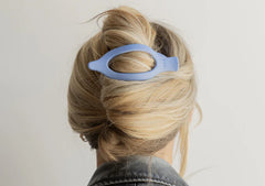 Kaxi Lay Down Claw 2.0 in Dusty Blue holding a French twist, back view