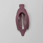 Kaxi Lay Down Claw 2.0 in Plum, a slim oval claw clip on a gray background