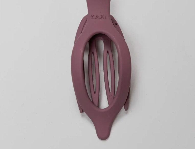 Kaxi Lay Down Claw 2.0 in Plum, a slim oval claw clip on a gray background