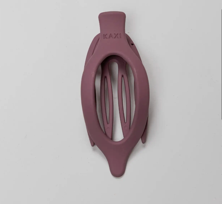 Kaxi Lay Down Claw 2.0 in Plum, a slim oval claw clip on a gray background