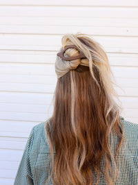 Kaxi Lay Down Claw 2.0 in taupe holding a half-up style in long blonde hair, back view