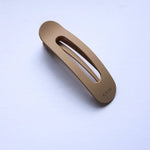 Kaxi Lay Down Claw hair clip in matte taupe shown open at an angle
