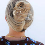 Kaxi Lay Down Claw hair clip in Shiny Clear holding a French twist, back view
